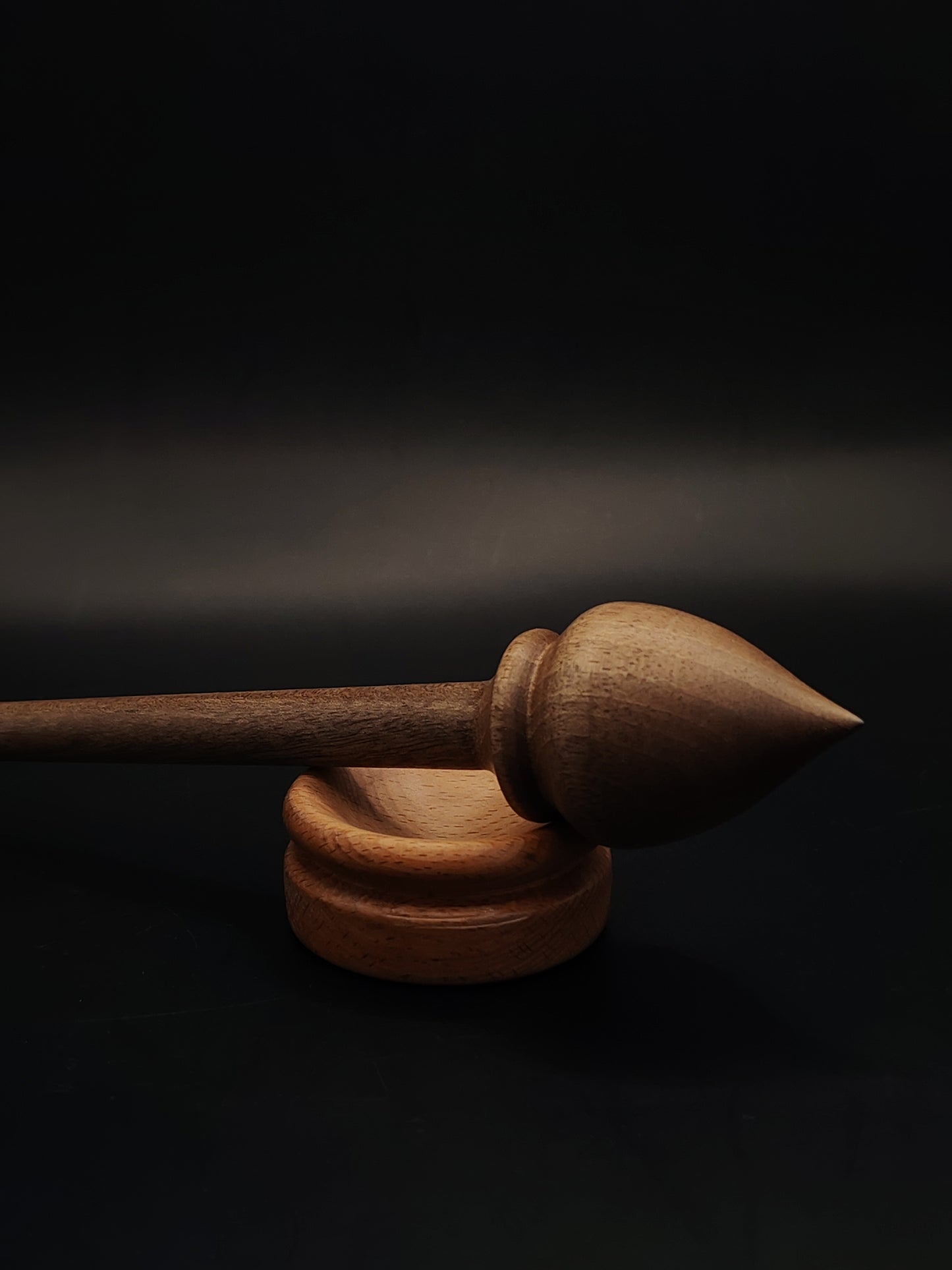 Support spindle crafted in walnut, balanced in beech bowl for handspinning yarn