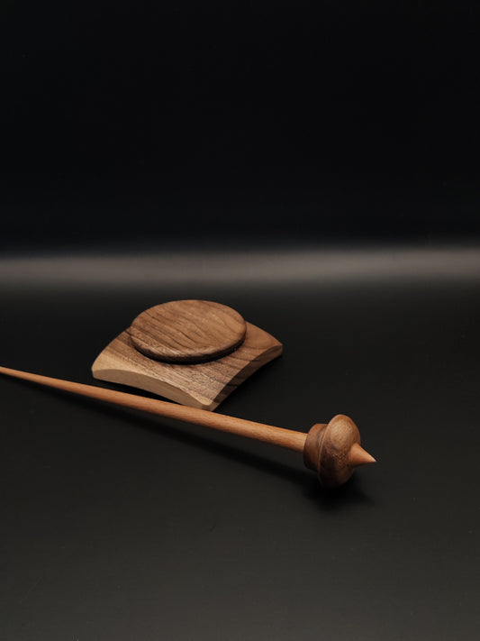 Handcrafted wooden support spindle featuring a cherry shaft and walnut whorl, paired with a uniquely designed walnut and oak support bowl. The set highlights natural wood finishes and skilled craftsmanship.