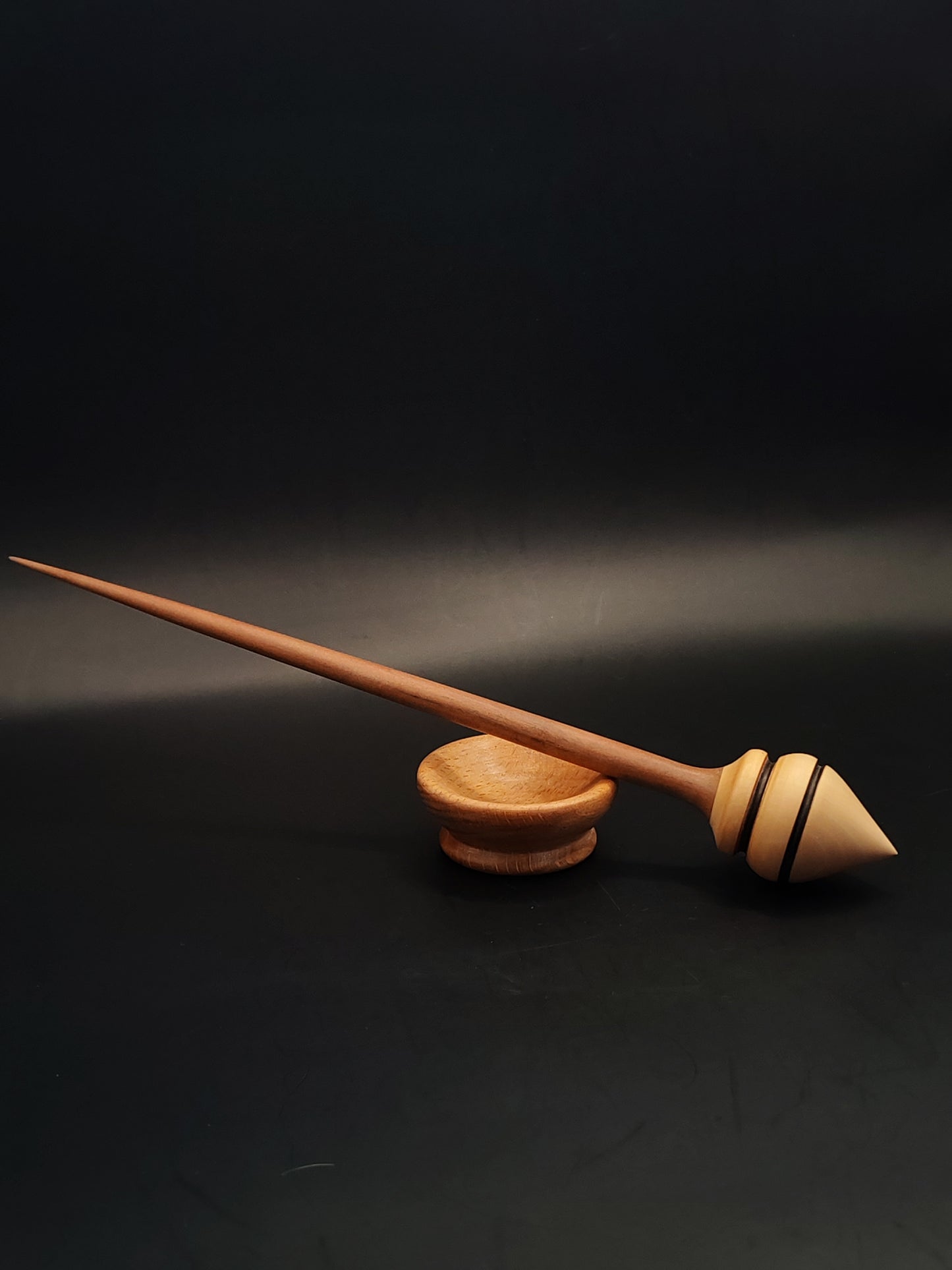 Support spindle crafted from plum and pear woods, paired with smooth beech bowl