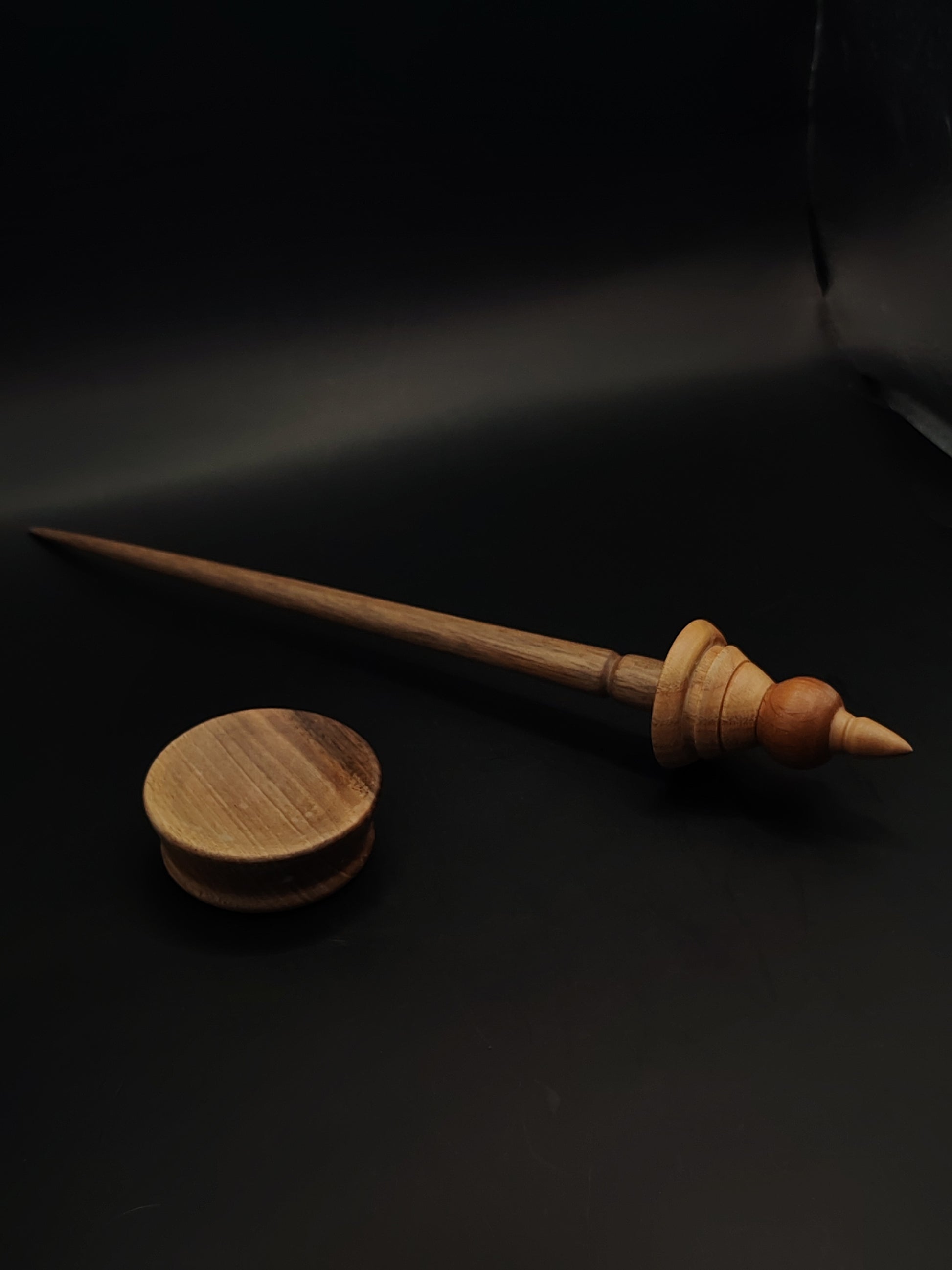 Balanced support spindle handcrafted with rich walnut shaft and dual-tone whorl