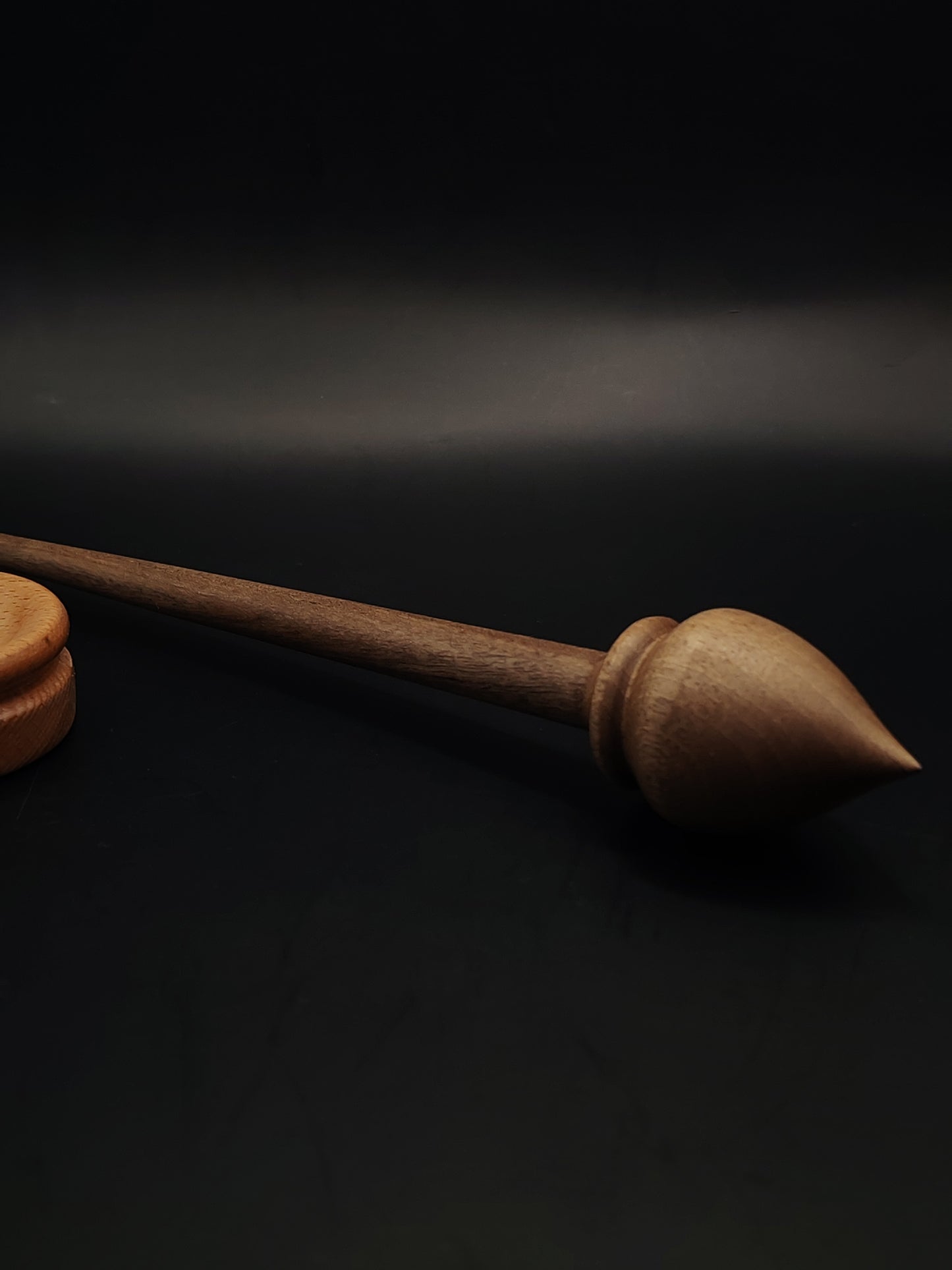 Handcrafted walnut support spindle paired with smooth beech spinning bowl