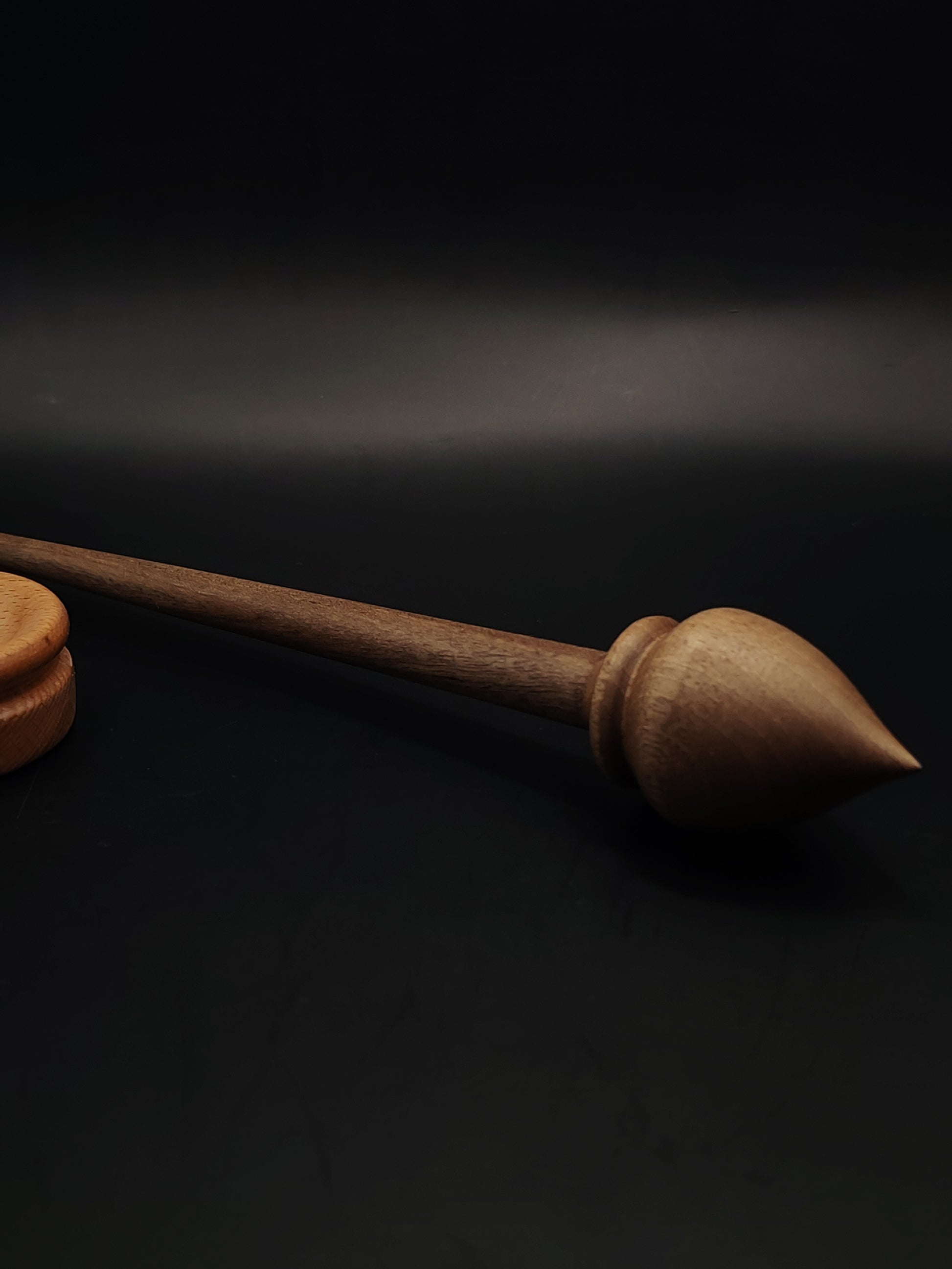Handcrafted walnut support spindle paired with smooth beech spinning bowl