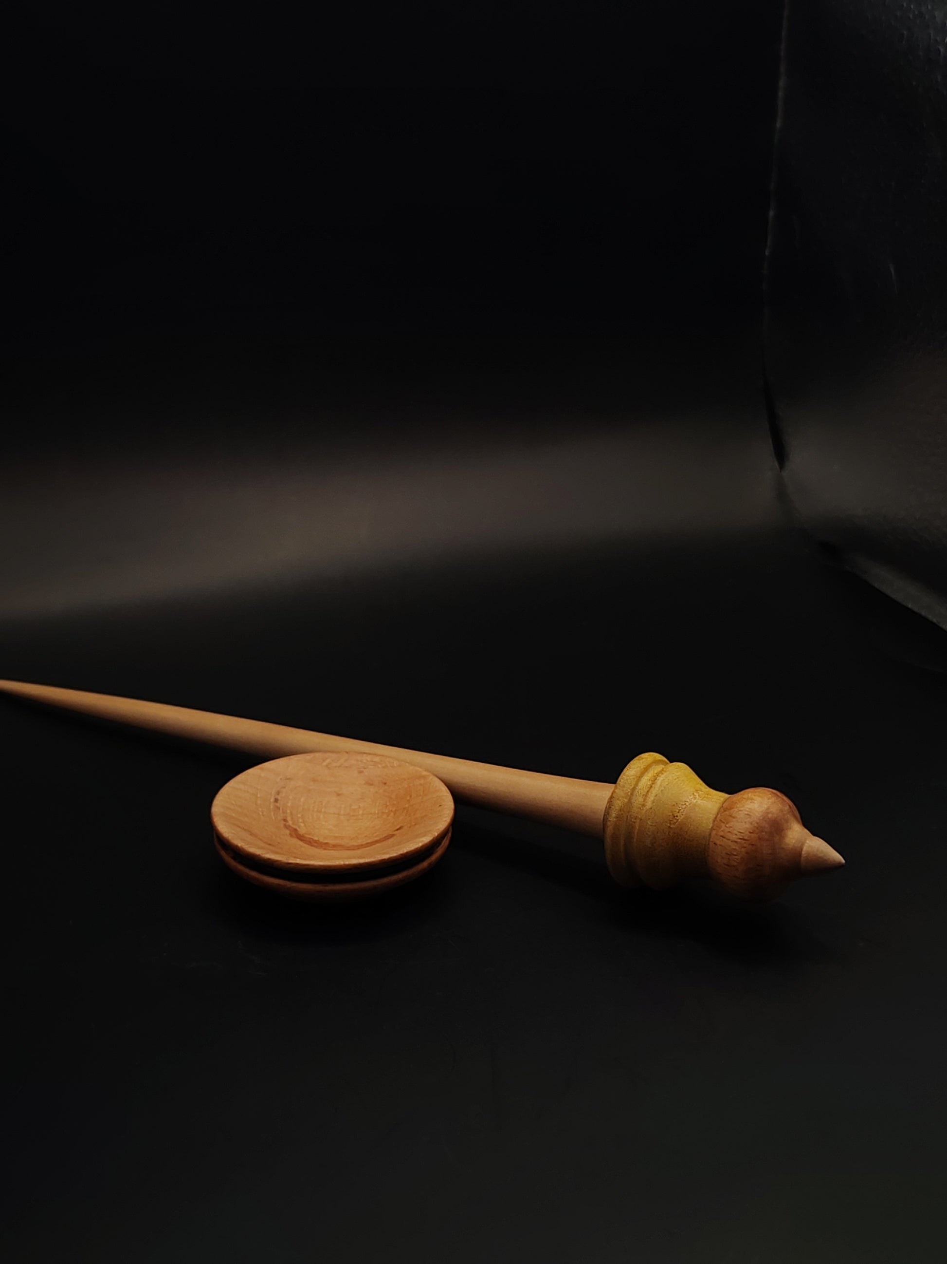 Support spindle with apple wood shaft and beech-mulberry whorl, displayed in beech bowl