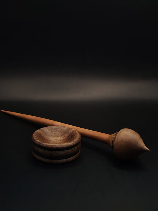 Handmade support spindle with plum wood shaft and walnut whorl, paired with walnut bowl