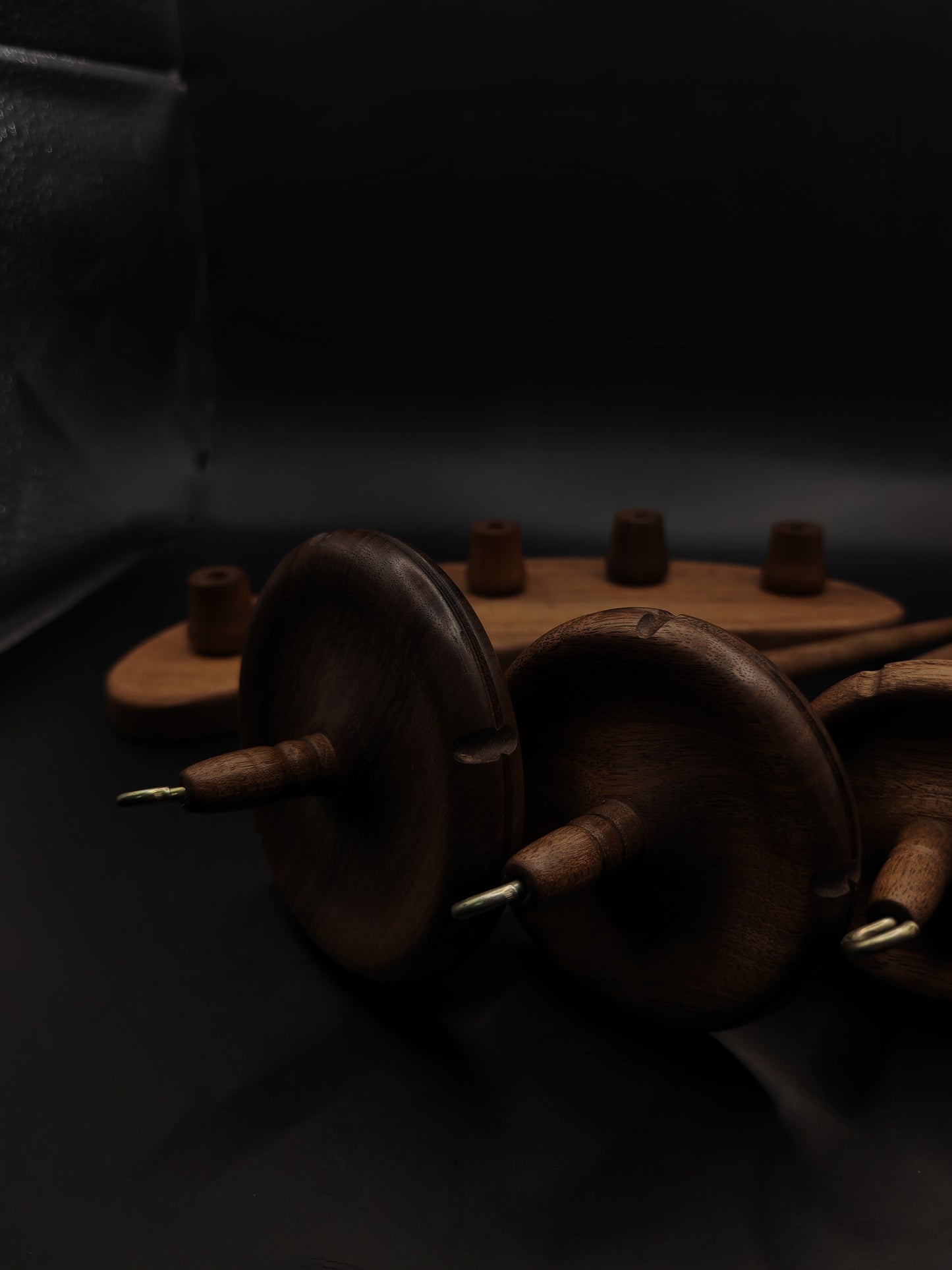 Drop Spindle Set of 5 walnut wood spindles arranged on a dark background, showcasing their craftsmanship and design.