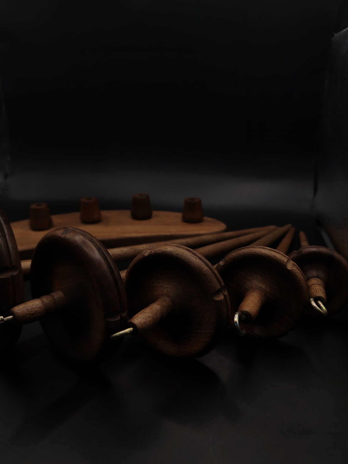 Drop Spindle Set of 5 Walnut Wood complete spinning set displayed against a dark background.