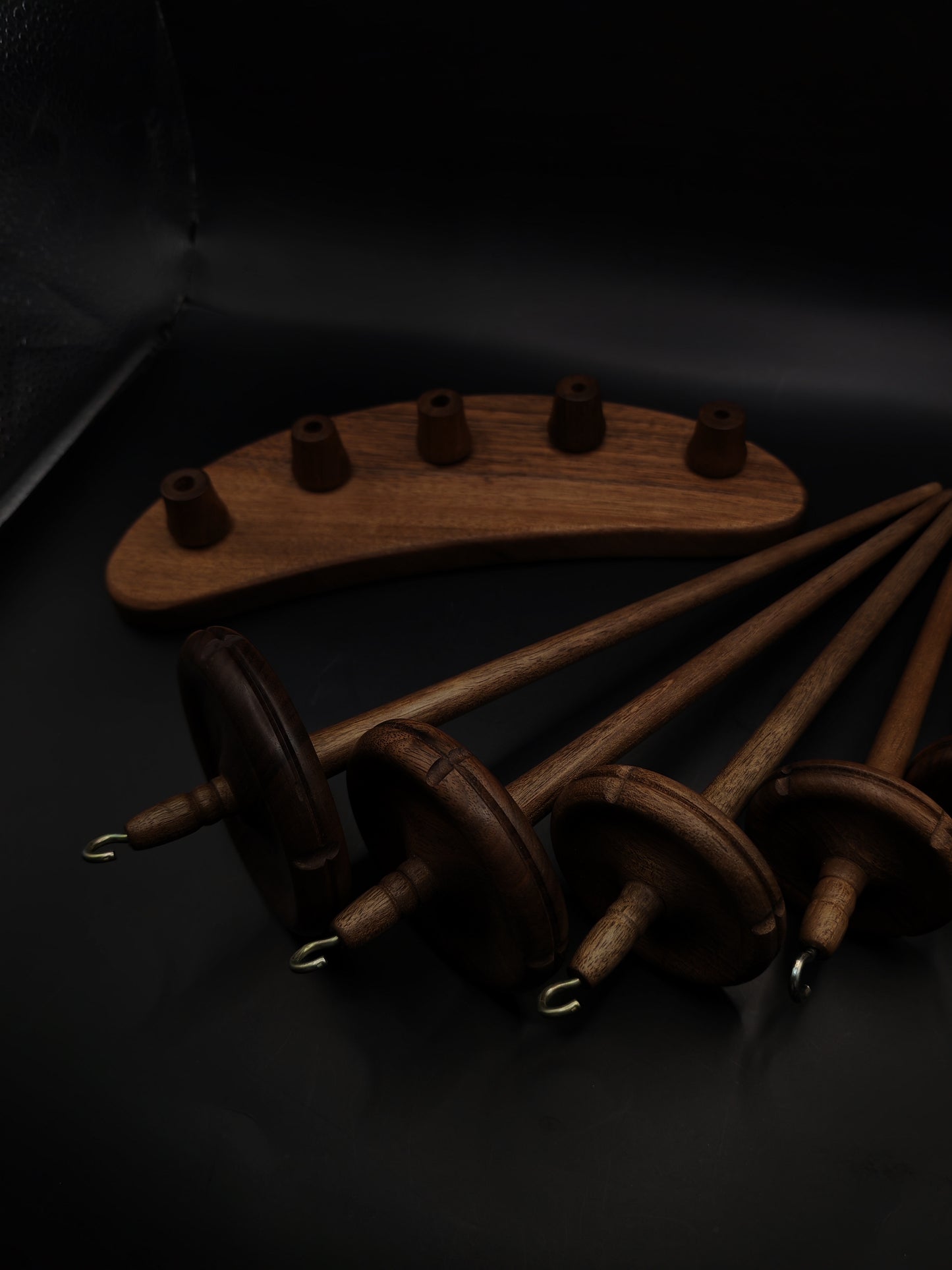 Drop Spindle Set of 5 walnut wood spindles with a display holder for various hand spinning projects.